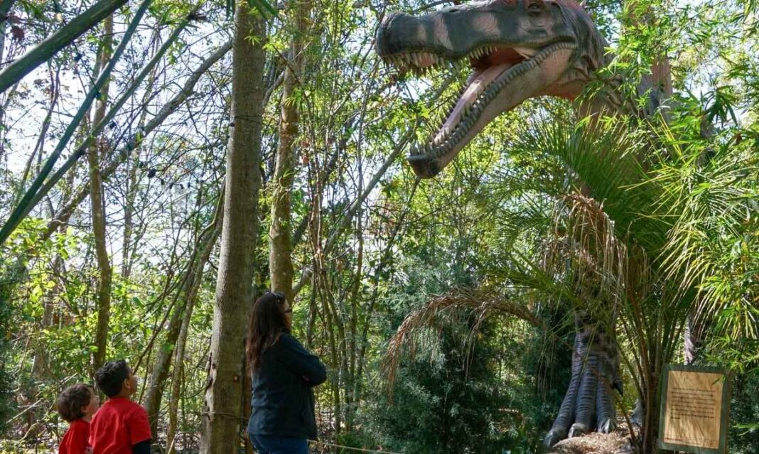 Family explores dinosaur exhibit at Dow Gardens in Midland Michigan during family getaway sweepstakes experience