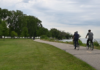 People riding bikes along a lakeside trail at a Macomb County metropark