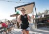 The ultimate family guide to visiting Muskegon Server carrying drinks at The Deck in Muskegon, a lively lakeside spot for family friendly dining with outdoor seating and views