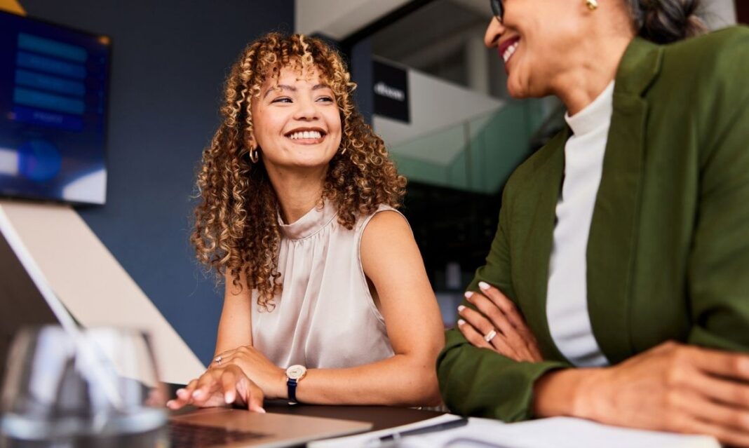 Young professional smiling at work after earning a certificate and experiencing improved job satisfaction and career growth